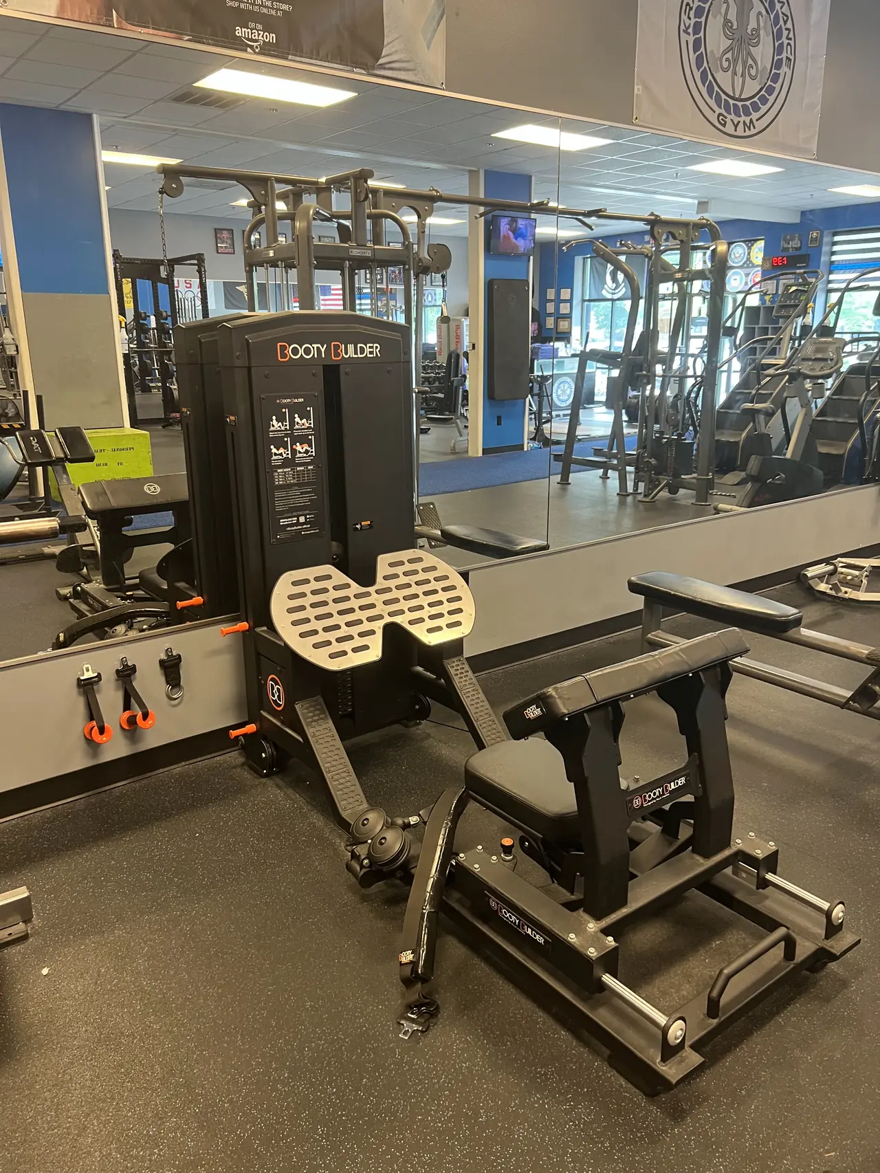 Booty Builder hip-thrust machine against the mirrored wall.